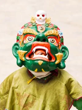 Monk in dharmapala mask performs a religious Cham Dance of Tibetan Buddhism 스톡 사진