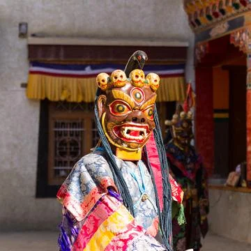 Monk in dharmapala mask performs a religious Cham Dance of Tibetan Buddhism Stock Photos