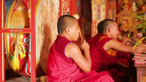 Monk drumming the ritual prayer drum in a Buddhist monastery Stock Footage 77443594