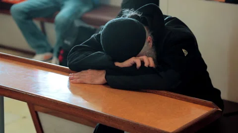 The monk fell asleep at the table while sailing on the ferry to Mount Athos. Stock Footage 252743375