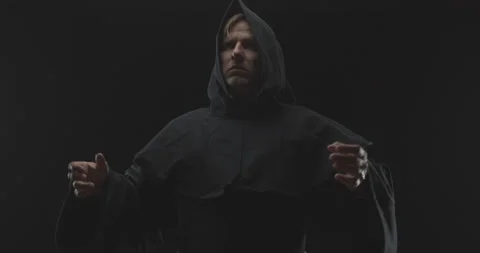 Monk Gaze Straight Down as He Slowly Spreads His Hands to His Sides Praising Video stock 156198693