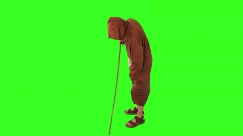 Monk hoeing weeds alt view Stock Footage 76226940
