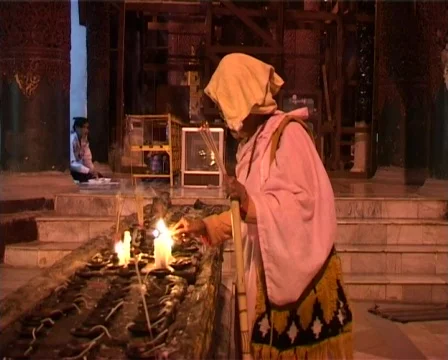 Monk is lighting candles Stock Footage 314577