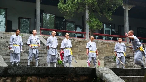 Monk performing with sword while other students stand back Stock Footage 88677491