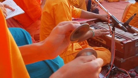 Monk plays hand-pumped harmonium. Stock Footage 119054669