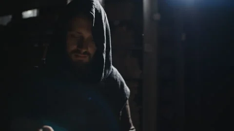 Monk is reading a book in dark Stock Footage 99080022