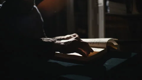 Monk is reading an old book in dark Video stock 99075001
