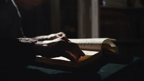 Monk is reading an old book in dark Stock Footage 131082235