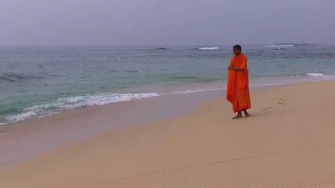 Monk saffron robe walking beach sri lanka Video stock 165954005