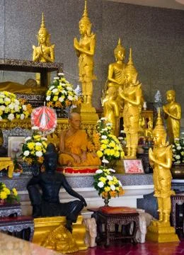 A monk sits in a Buddhist temple. Stock Photos
