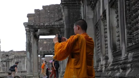Monk taking photo inside Angkor Wat Stock Footage 53137113