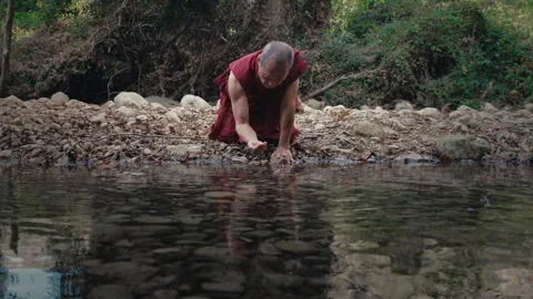 Monk taking water from the pond Stock Footage 275153456