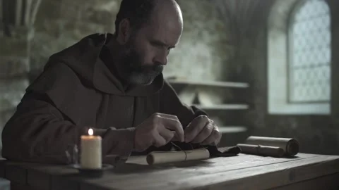 Monk tying a knot with a linen string on a scroll, medium shot Stock Footage 337930123
