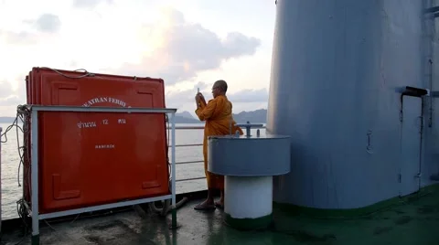 Monk Using Cell Phone While Sailing on the Ship in the Sea Stock Footage 46702565