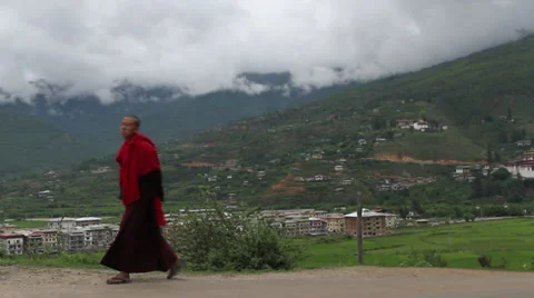 Monk walking by camera in mountains 스톡 동영상 37163005