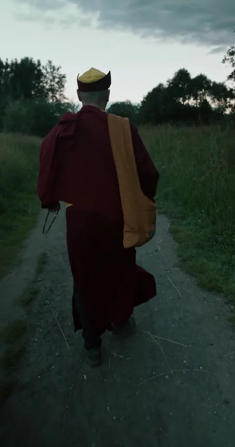 Monk Walking on Rural Path at Dusk, Serene Journey 스톡 동영상 327043886