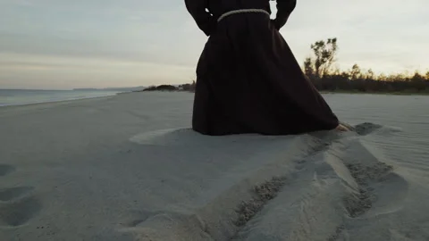 Monk Walks on the Beach in Prayer At Sunset Stock Footage 271625164