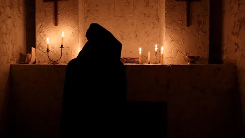 The monk walks the dark room to the altar Stock Footage 88713430