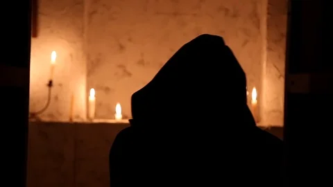 The monk walks the dark room to the altar Stock Footage 88713434