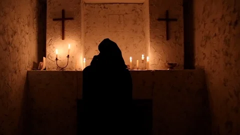 The monk walks the dark room to the altar Stock Footage 88713436