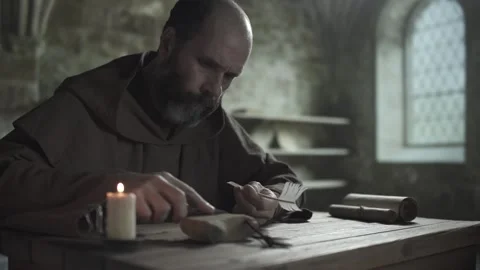 Monk wetting whetstone with a finger and sharpening penknife blade, medium shot 스톡 동영상 337649283