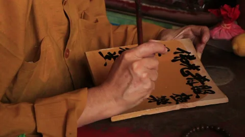 Monk writes with a brush Stock-Footage 37311645