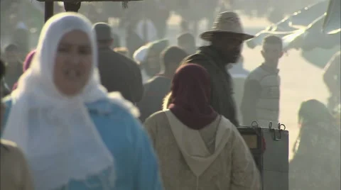 A monkey chained to a stall in an everyday market street scene, Morocco Video stock 68446556
