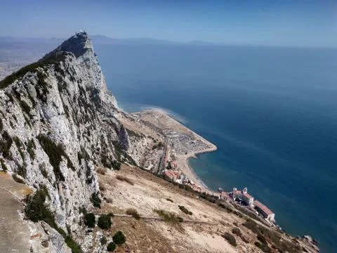 Monkey on panoramic view on the Gibraltar and Big Rock at sunny summer weathe Stock Photos