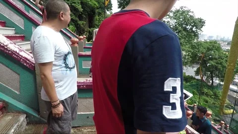 Monkey on staircase to Main Temple cave, Murugan statue, Batu caves, Malaysia 動画素材 194475265