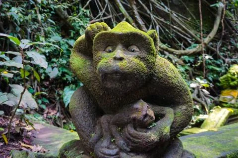 Monkey statue in Bali covered with moss Stock Photos