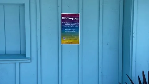 Monkeypox sign displayed at Fire Island on a blue wall background Stock Footage 200573470