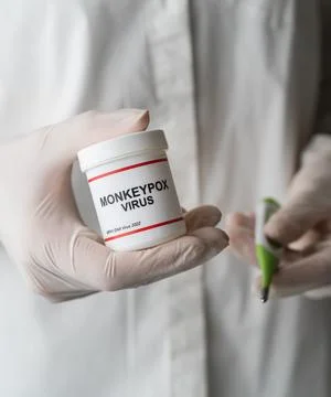 Monkeypox virus bottle in doctors hand with gloves Stock Photos