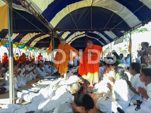 Monks and Thai people perform religious rituals. Stock Photos