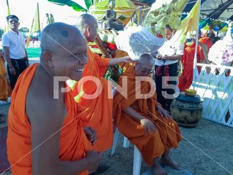 Monks and Thai people perform religious rituals. Stock Photos