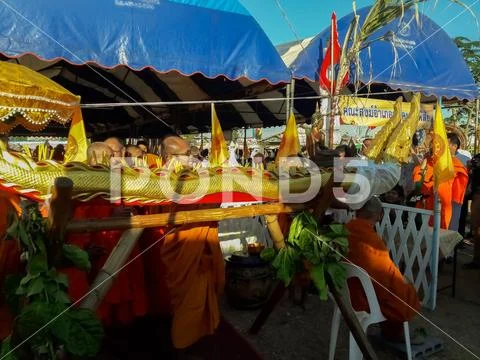 Monks and Thai people perform religious rituals. Stock Photos
