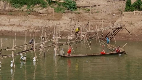 Monks building bamboo bridge across the River in Luang Prabang Laos Stock Footage 74684348