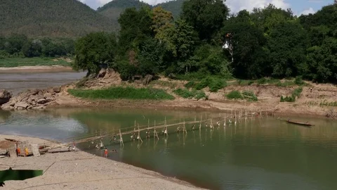 Monks building bamboo bridge across the River in Luang Prabang Laos Stock Footage 74684368