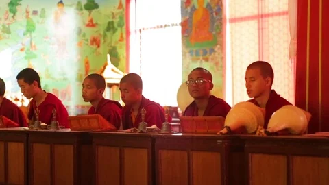 Monks sitting in a row with conch shells Stock Footage 77443927