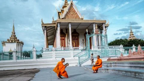 Monks taking photos with iPad in front of the Royal Palace, Cambodia Stock Photos