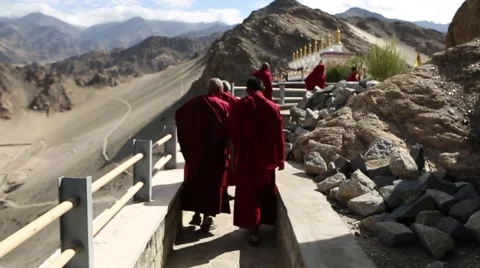 Monks walking to Stupas at Buddhist Monastery Stock Footage