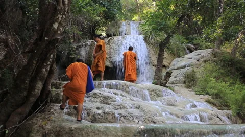 Monks at a waterfall Stock Footage 46347705
