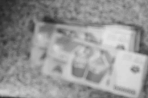 Monochromatic blurred image showcasing a stack of printed brochures Stock Photos