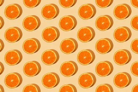Monochromatic creative pattern made of fresh orange. Juicy citrus pastel back Stock Photos