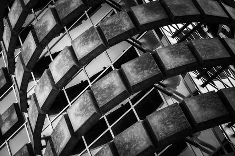 Monochromatic geometric pattern of building facade creating dynamic play of Stock Photos