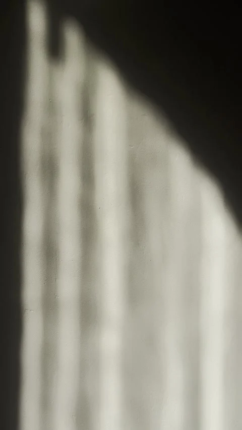 Monochromatic minimalist sunlight casting architectural shadow ripples across Vídeos de archivo 334655862