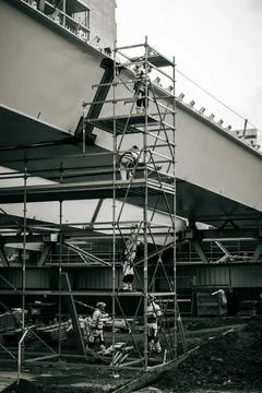 A monochromatic picture of five workers at a construction site Stock Photos