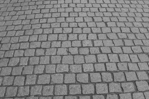 Monochrome cobblestone street pattern featuring vintage square stones. ideal  Stockfoto's