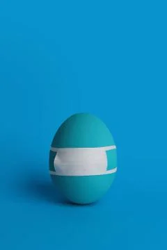 Monochrome Easter quarantine concept. Egg in protective medicine mask. Stock Photos