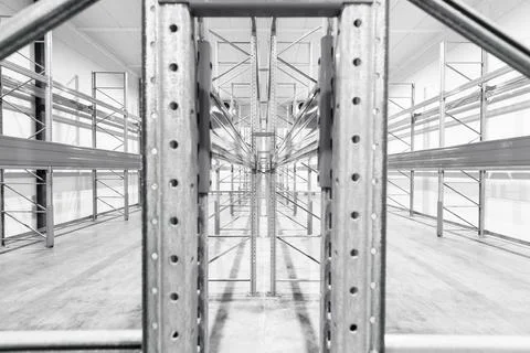 Monochrome Interior of empty warehouse with empty racks Stock Photos