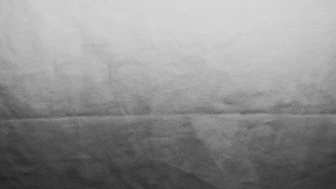 Monochrome linen fabric texture gradient ripples slowly under cinematic studio l Stock Footage 337025607